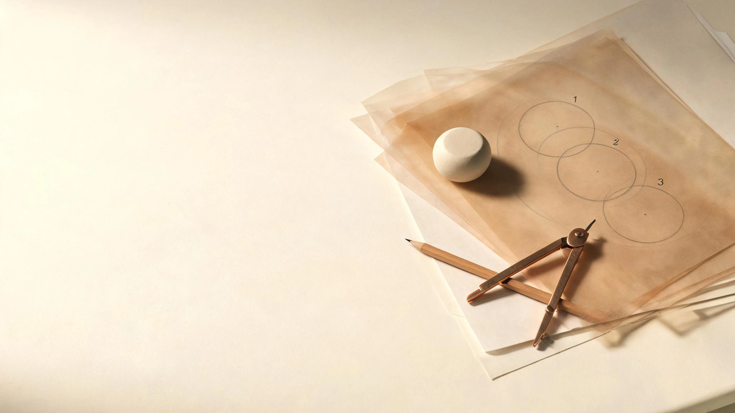 Layered vellum diagrams with a brass compass and ceramic paperweight